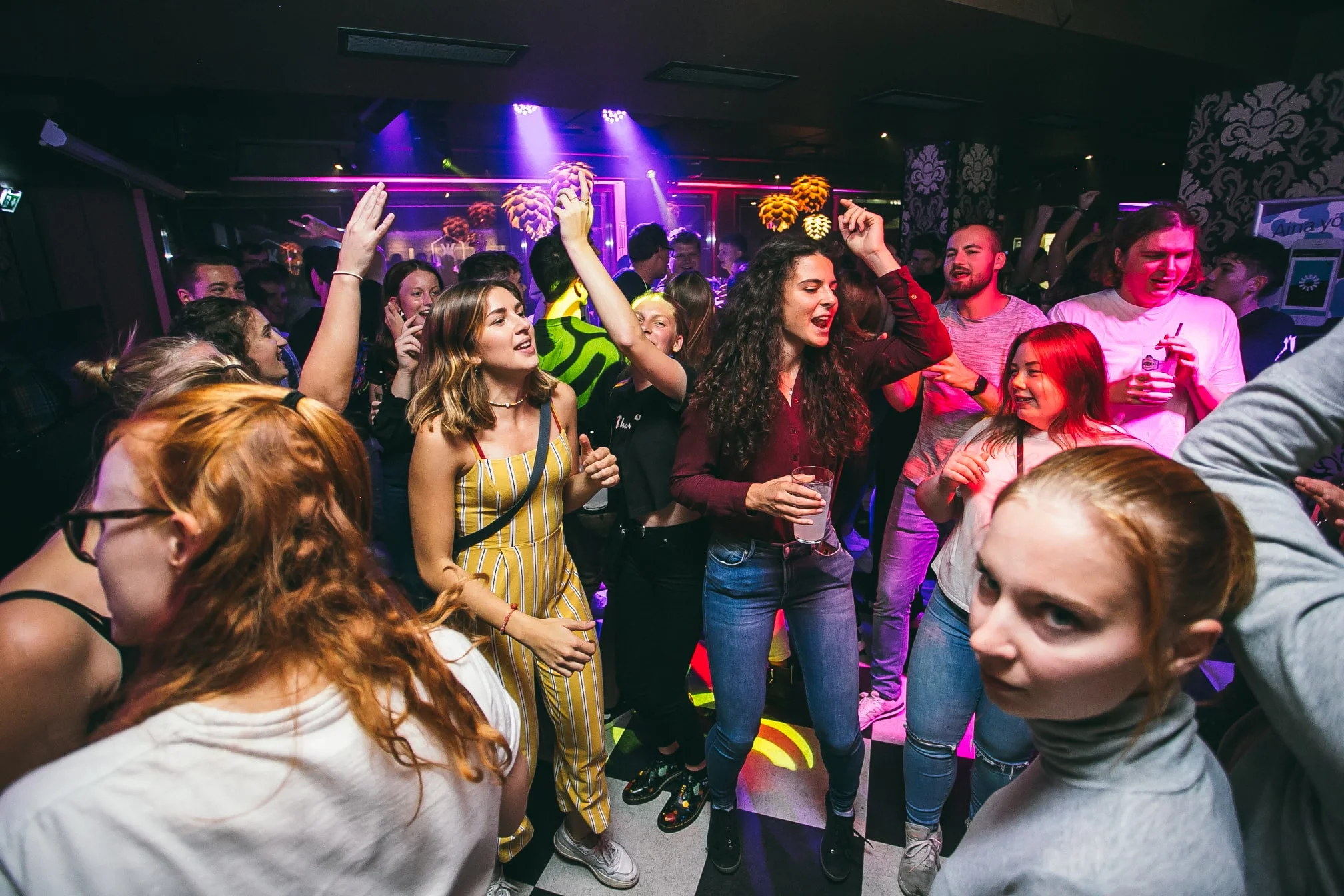 Juhlijoita tanssimassa värikkäissä klubivaloissa